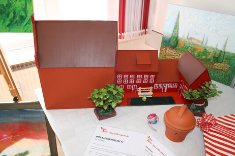 Gebasteltes Hausmodell und Monatsplan im TRAVE-Treff